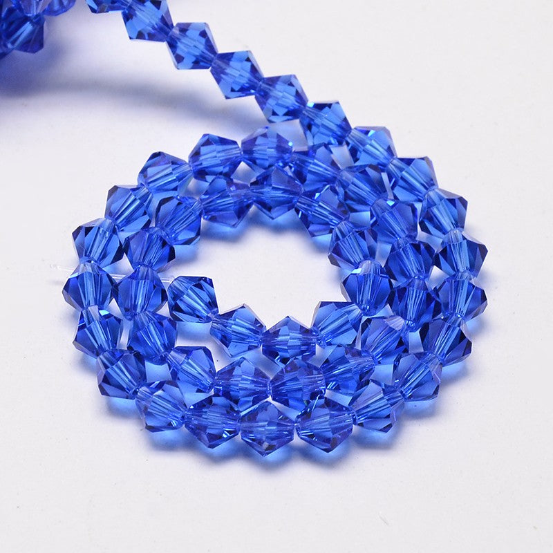 חרוזי זכוכית חיתוך יהלום בצבע כחול כהה שקוף 4 מ"מ